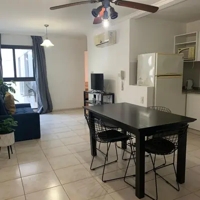 a kitchen and living room with a black table and chairs at Hipólito Yrigoyen 150 in Cordoba