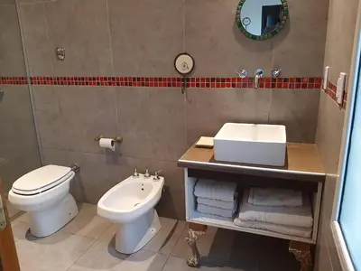 a bathroom with a white toilet and a sink at Indigo CCH in Carpintería