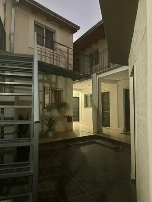 an empty courtyard of a house with a staircase at ACOGEDOR Dpto Pasaje Tucumán in Alta Gracia