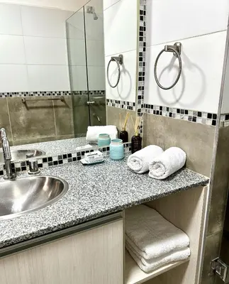 a bathroom with a sink and a mirror at Cabaña Sierras Chicas in Villa Anizacate