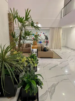 a living room filled with lots of potted plants at Departamento Veneto Village - D - in Villa Parque Siquiman