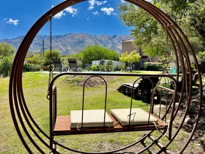 a swing in a yard with mountains in the background at Departamento con vista a las sierras en Planta Alta para 2 a 4 personas in Merlo