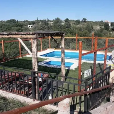 a swimming pool with a fence around it at VASOS Y BESOS - Cabaña 1 in Villa Parque Siquiman