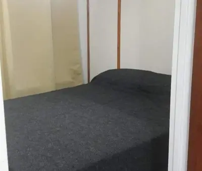 a bed in a room with a closet at VASOS Y BESOS - Cabaña 1 in Villa Parque Siquiman