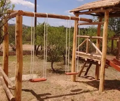 a playground with a bench and a swing at Cabaña 2 in Cordoba