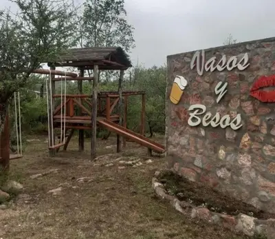 a picnic area with a picnic table and a sign at Cabaña 3 in Bialet Massé