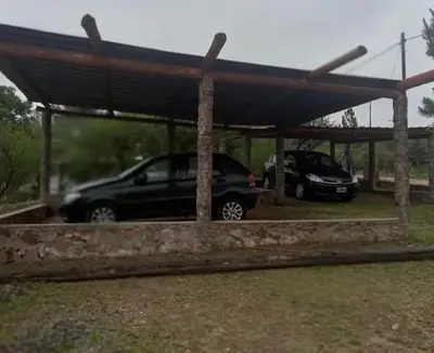two cars parked under a carport at Cabaña 3 in Bialet Massé