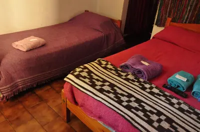 two beds sitting next to each other in a room at Hotel La Marina in Villa Carlos Paz