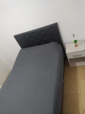 a black bed in a room with a desk at Dto Costanera Antigua Cerveceria 3 dorm 2 cocheras 4 cuadras del centro in Cordoba