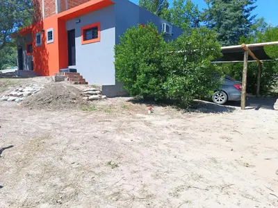 a house with a car parked in front of it at Complejo Barranca Poceña in Quebrada de los Pozos