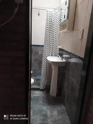 a bathroom with a sink and a shower at Luna in Villa Cura Brochero
