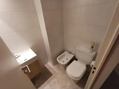 a small bathroom with a toilet and a sink at SERIETÁ 1 dormitorio con pileta y terraza in Cordoba