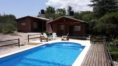 a swimming pool in front of a house at Cabaña Las Marias 4 in Cordoba