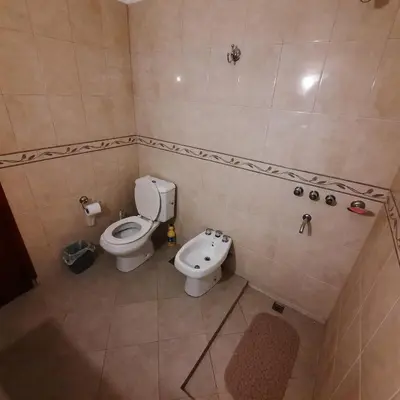 a small bathroom with a toilet and a sink at El sueño de papá in Santa María