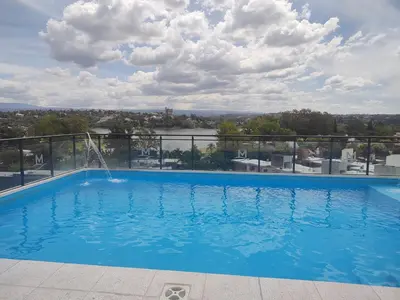 a swimming pool on the roof of a building at Villa Carlos Paz departamento con pileta in Villa Carlos Paz