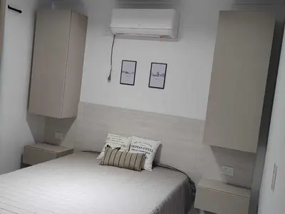 a bedroom with a bed with two pillows on it at Dpto frente al Lago Carlos Paz in Villa Carlos Paz