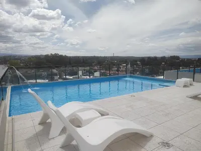 a large swimming pool on top of a building at Dpto frente al Lago Carlos Paz in Villa Carlos Paz