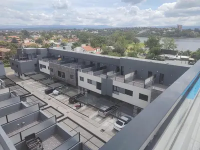 an overhead view of a building with a parking lot at Dpto frente al Lago Carlos Paz in Villa Carlos Paz