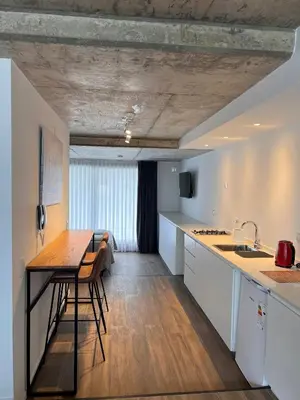 a kitchen with a table and a counter top at Departamentos en Gral Paz a pasos de clínicas in Cordoba
