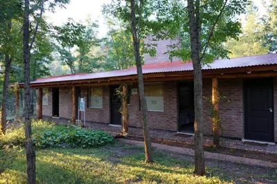 a brick building with trees in front of it at Santa Mate in Nono