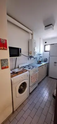 a kitchen with a washer and dryer in it at cordoba departamentos por dia cañada in Cordoba