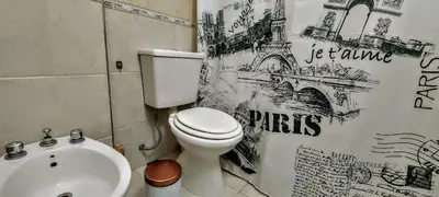 a bathroom with a white toilet and a sink at Oasis depto en centro carlos paz in Villa Carlos Paz