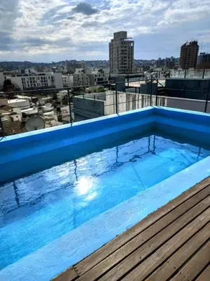 a swimming pool on the roof of a building at Oasis, departamento en Carlos paz in Villa Carlos Paz