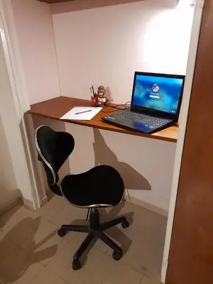 a desk with a laptop computer on top of it at Exclusivo Departamento en Nva Cba!!! in Cordoba