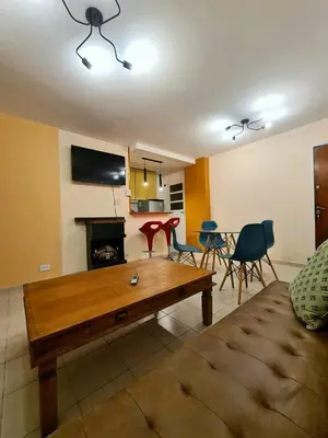 a living room with a couch and a table and chairs at Exclusivo Departamento en Nva Cba!!! in Cordoba