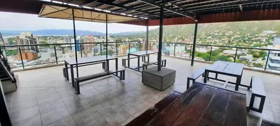 a room with two tables and a view of a city at Miralejos 7 Music in Villa Carlos Paz