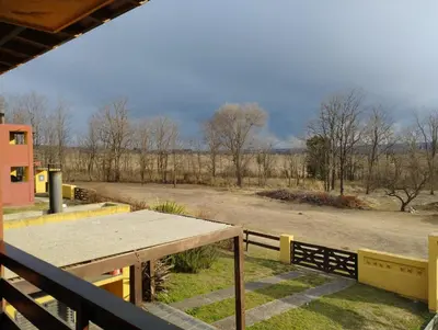 a picnic table on a porch with a view of a road at Paraíso Serrano 17 in Villa Ciudad Parque