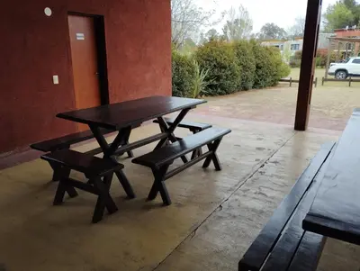 a picnic table and two benches on a patio at Paraíso Serrano 16 in Villa Ciudad Parque