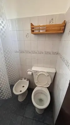 a bathroom with a toilet and a sink at 760 A Apartamentos in Alta Gracia