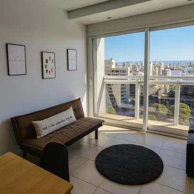 a living room with a couch and a large window at Coral State Premium Tower in Cordoba