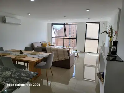 a living room with a table and a couch at Calasanz Premium in Cordoba