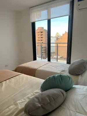 two beds with pillows in a room with a window at Calasanz Premium in Cordoba