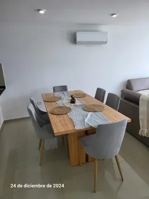 a wooden table in a room with chairs and a couch at Calasanz Premium in Cordoba