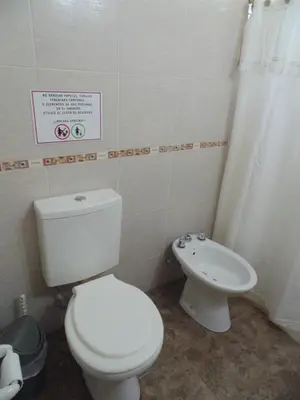 a bathroom with a white toilet and a bidet at Cabañas los amigos Chañar in Potrero de Garay