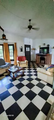 a living room with a black and white checkered floor at CASA de Campo EL LULY in La Bolsa