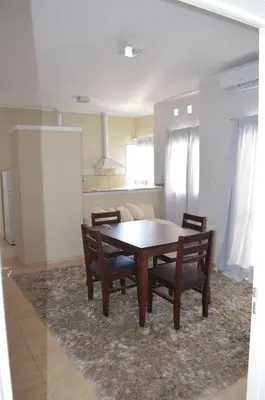 a dining room with a wooden table and chairs at Complejo Fatima in Villa Dolores