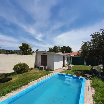 a house with a swimming pool in a yard at Departamento Nini Villa Del Dique in Villa del Dique