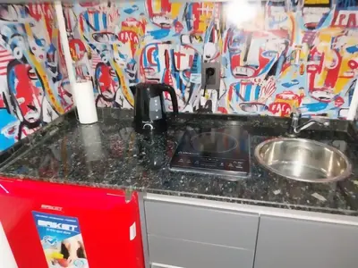 a laptop sitting on a counter next to a sink at Departamento 610 - Edificio VILAUT by INMOVE Temporarios in Cordoba