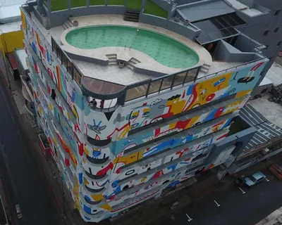 a building with a pool painted on the side of it at Departamento 610 - Edificio VILAUT by INMOVE Temporarios in Cordoba