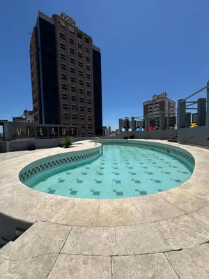 a large pool in the middle of a city at Departamento amoblado con Amenities 104 INVERHOME INMOBILIARIA in Cordoba