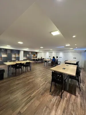 a large room with tables and chairs and people in the background at Departamento amoblado con Amenities 104 INVERHOME INMOBILIARIA in Cordoba