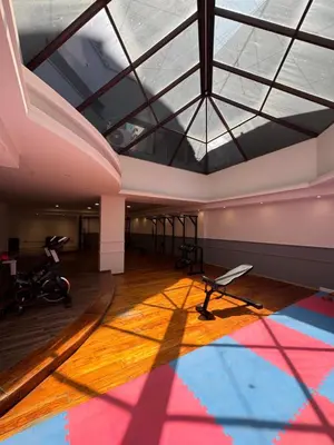 a large room with a skylight and a gym at Departamento amoblado con Amenities 104 INVERHOME INMOBILIARIA in Cordoba