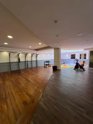 an empty room with a wooden floor and a room with motorcycles in it at Departamento amoblado con amenities 106 INVERHOME INMOBILIARIA in Cordoba