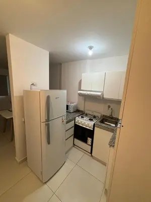 a small kitchen with a refrigerator and a stove at Departamento para dos personas in Cordoba
