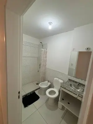 a white bathroom with a toilet and a sink at Departamento para 2 personas in Cordoba