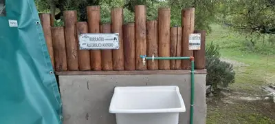 a toilet in front of a wooden fence at Cabaña LA LUGARDA in Cuesta Blanca